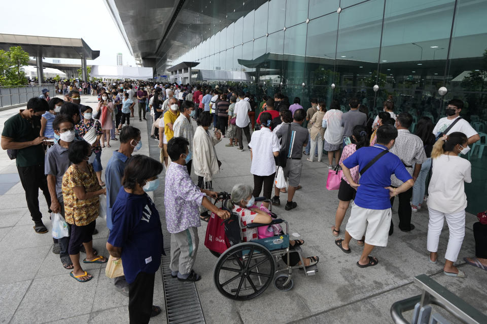 Residents wait on line to receive shots of the AstraZeneca COVID-19 vaccine at the Central Vaccination Center in Bangkok, Thailand, Thursday, July 22, 2021. (AP Photo/Sakchai Lalit)