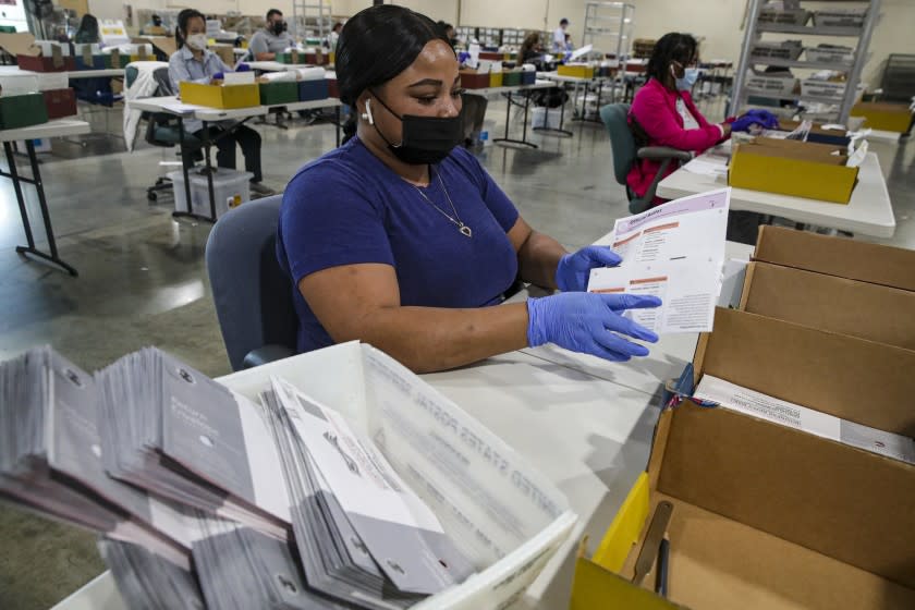 Pomona, CA - September 07: Election worker Tameka Augustus inspects a ballot that have been received for the Sept. 14, recall election at the Los Angeles County Registrar of Voters satellite office at Fairplex on Tuesday, Sept. 7, 2021 in Pomona, CA. (Irfan Khan / Los Angeles Times)