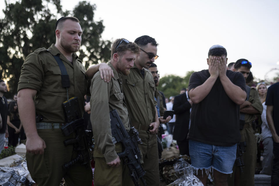 Mourners attend the funeral of the Israeli man Sagiv Ben Svi, killed by Hamas militants while attending a music festival, at a cemetery in Holon, central Israel, Thursday, Oct. 26, 2023. More than 1,400 people were killed and over 200 taken captive in an multi-front attack by the militant group that rules Gaza on Oct. 7.(AP Photo/Petros Giannakouris)