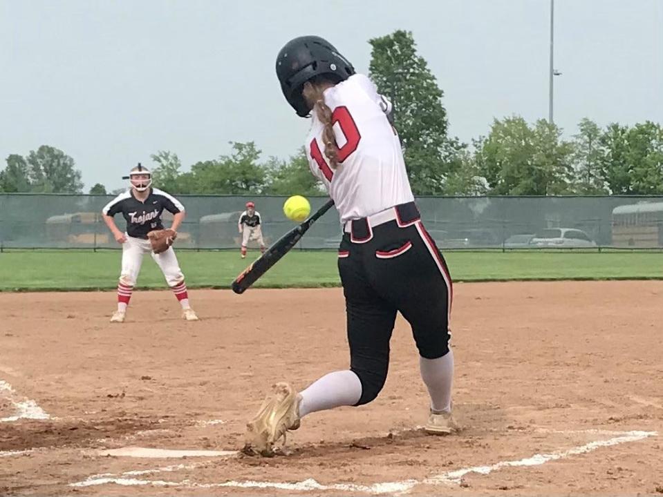 Cardington's Dana Bertke drives the ball for a two-run home run in the first inning during a Division III district championship softball game Friday night at Pickerington Central.