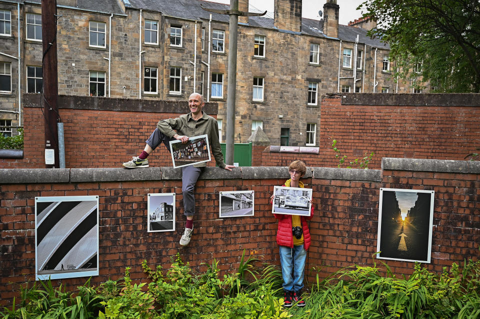 <p>GLASGOW, SCOTLAND - SEPTEMBER 17: Brian Hartley and Dylan Lombard (R) pose beside their photographic exhibition in a tenement garden on September 17, 2021 in Glasgow, Scotland. “Stills of a Lockdown City” features images taken during the 2020 coronavirus lockdown by Glasgow-based artist Brian Hartley and 18-year-old Dylan Lombard, and aims to offer “a perspective that allows us to make more sense of the world”. It will take place on September 18 and 19, 2021. (Photo by Jeff J Mitchell/Getty Images)</p>
