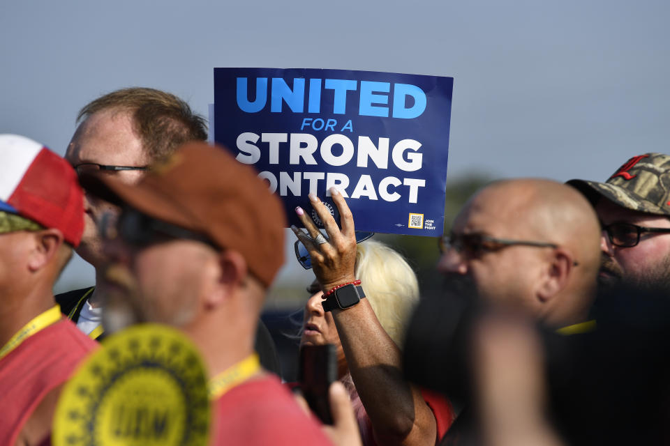 File - A member holds up a sign at a rally by United Auto Workers Local 863 in Louisville, Ky., on Aug. 24, 2023. eaders of the UAW union are considering targeted strikes at a small number of factories run by each of Detroit’s three automakers if they can’t reach contract agreements by a Thursday night, Sept. 12 deadline. (AP Photo/Timothy D. Easley, File)