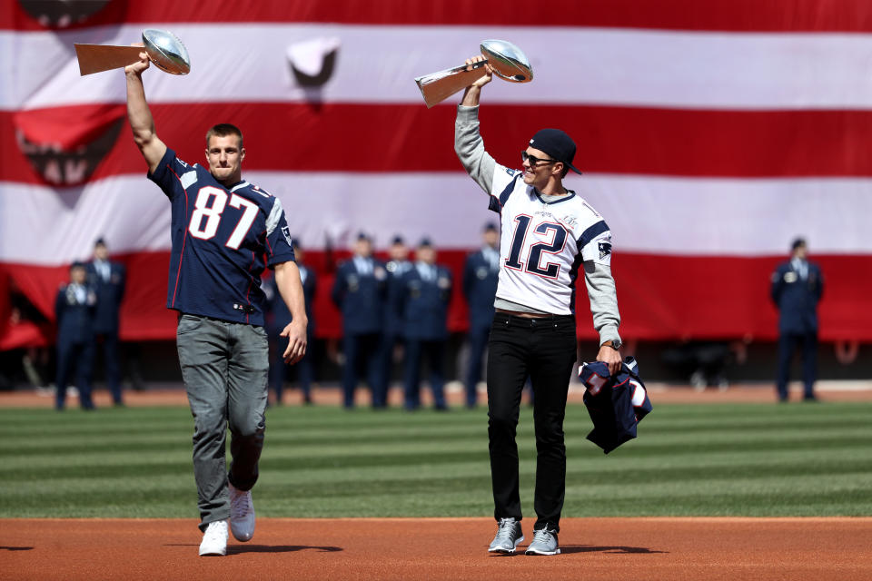  Rob Gronkowski #87 and Tom Brady #12 of the New England Patriots enter the field carrying Vince Lombardi trophies before the opening day game between the Boston Red Sox and the Pittsburgh Pirates at Fenway Park on April 3, 2017 in Boston, Massachusetts. (Photo by Maddie Meyer/Getty Images)