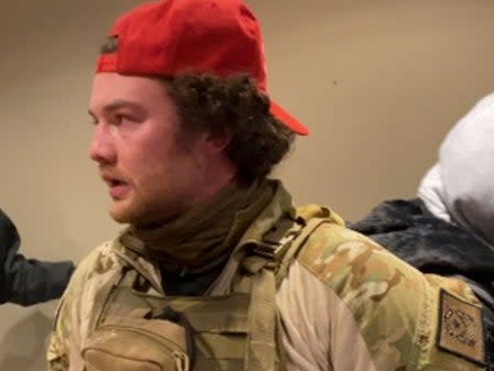 Robert Morss, 27, in tactical gear and a red MAGA hat during the Capitol riot. Mr Morss has been arrested and charged for his participation in the attack.  (FBI)