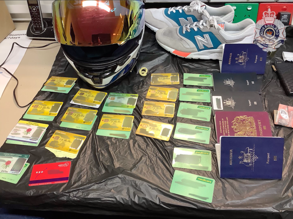 Pictured are 13 Queensland and New South Wales driver licences, four Australian passports, one UK passport and 13 Medicare cards police said they found in the man's bag. Source: Queensland police