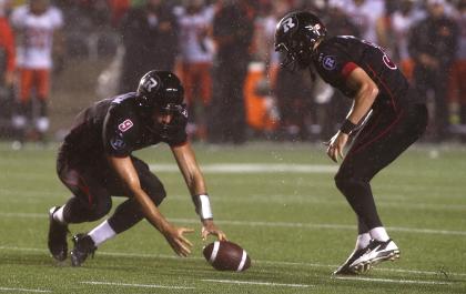 Danny O'Brien and Brett Maher bobble the ball on a field goal attempt against the B.C. Lions. (Getty Images)