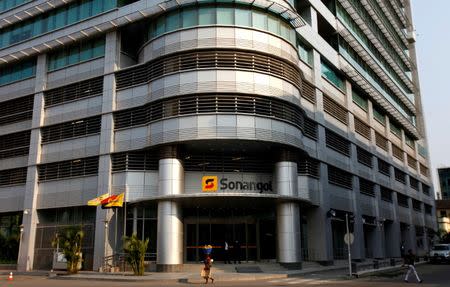 A woman walks past the head office of Angola's state oil company Sonangol in Luanda, Angola, August 26, 2012. REUTERS/Siphiwe Sibeko/File Photo