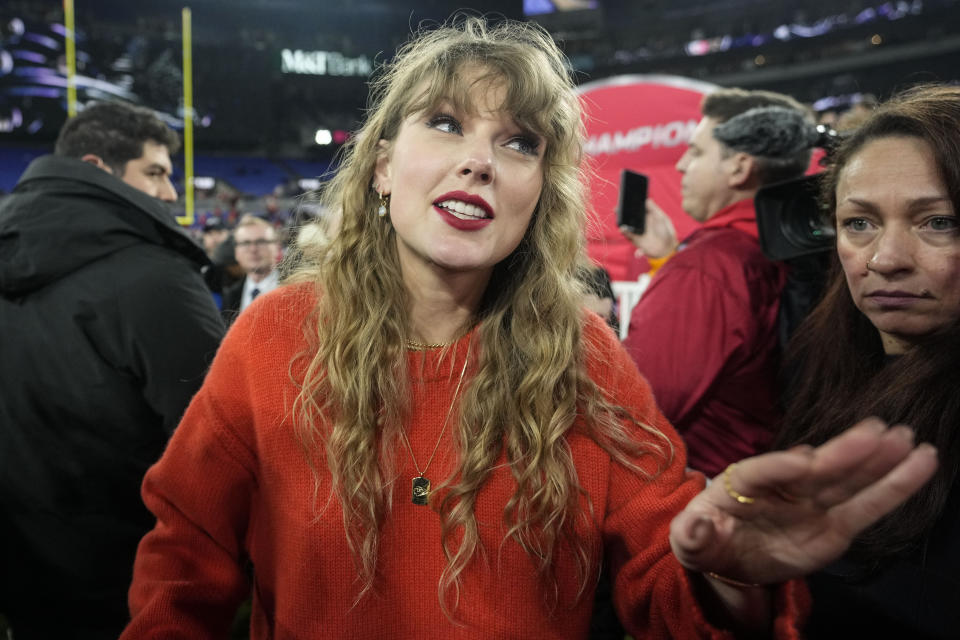 Taylor Swift speaks with people on the field after an AFC Championship NFL football game between the Baltimore Ravens and the Kansas City Chiefs, Sunday, Jan. 28, 2024, in Baltimore. The Kansas City Chiefs won 17-10. (AP Photo/Alex Brandon)