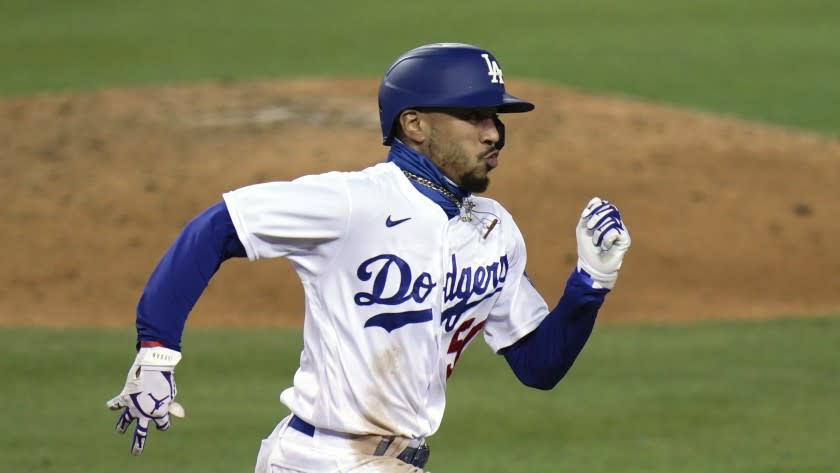 Los Angeles Dodgers' Mookie Betts runs to first base after hitting a single during the seventh inning of a baseball game against the San Diego Padres, Thursday, Aug. 13, 2020, in Los Angeles. (AP Photo/Jae C. Hong)