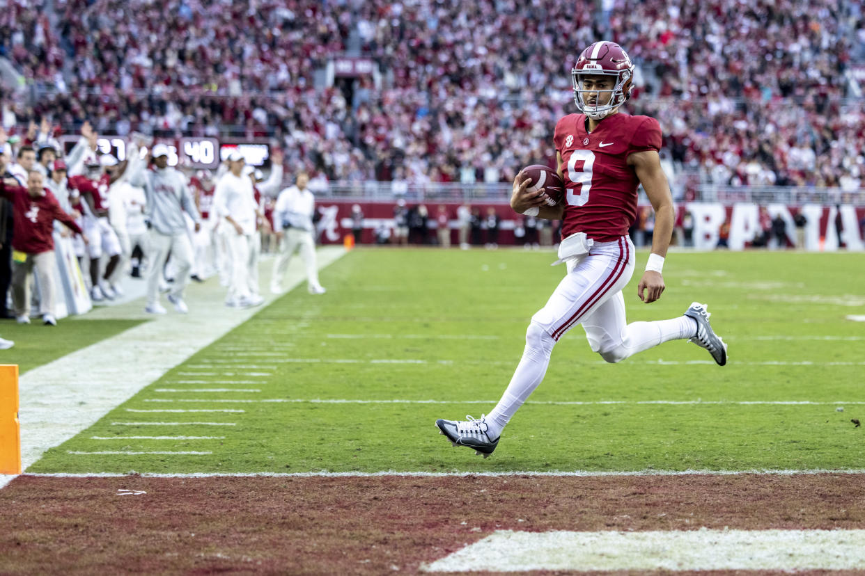 Alabama quarterback Bryce Young (9) scores a touchdown against Auburn during the first half of an NCAA college football game, Saturday, Nov. 26, 2022, in Tuscaloosa, Ala. (AP Photo/Vasha Hunt)
