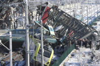 Members of rescue services work at the scene of a train accident in Ankara, Turkey, Thursday, Dec. 13, 2018. A high-speed train hit a railway engine and crashed into a pedestrian overpass at a station in the Turkish capital Ankara on Thursday, killing more than 5 people and injuring more than 40 others, officials and news reports said. (AP Photo/Burhan Ozbilici)