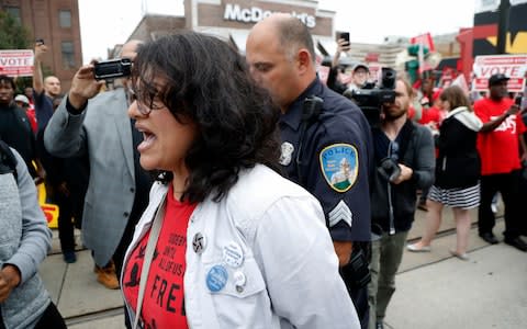 Rashida Tlaib as she is arrested following a protest - Credit: AP