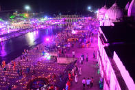 Hindu devotees gather while lighting earthen lamps on the banks of the River Sarayu on the eve before the groundbreaking ceremony of the proposed Ram Temple in Ayodhya on August 4, 2020. - India's Prime Minister Narendra Modi will lay the foundation stone for a grand Hindu temple in a highly anticipated ceremony at a holy site that was bitterly contested by Muslims, officials said. (Photo by SANJAY KANOJIA / AFP)