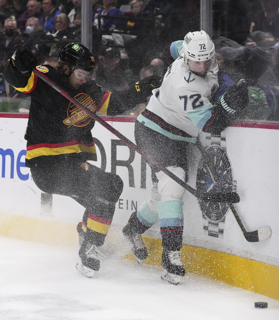 Vancouver Canucks' Vasily Podkolzin, left, and Seattle Kraken's Joonas Donskoi collide during the third period of an NHL hockey game Tuesday, April 26, 2022, in Vancouver, British Columbia. (Darryl Dyck/The Canadian Press via AP)