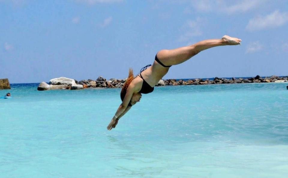 A woman diving into the sea.