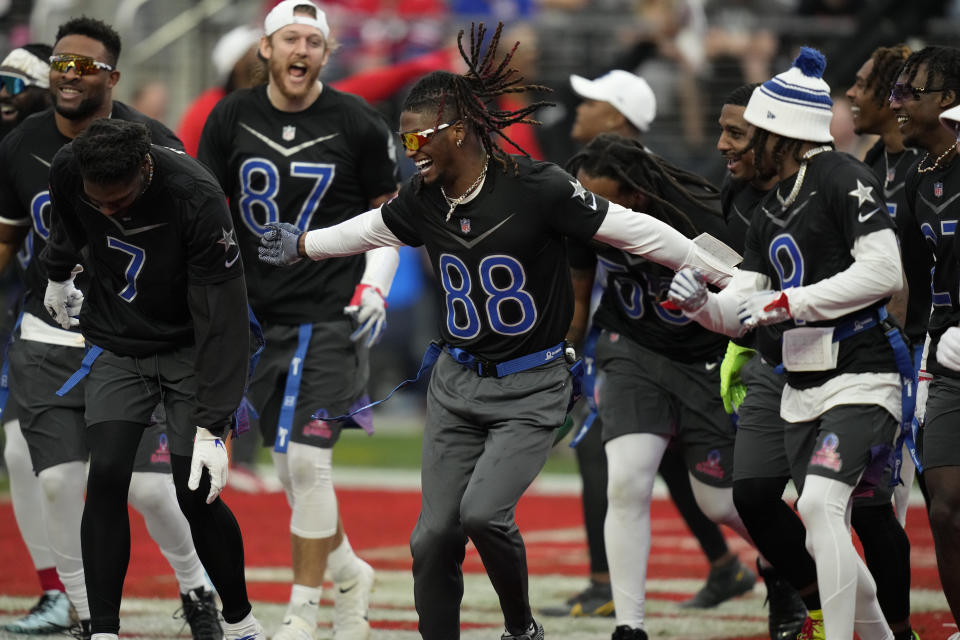 NFC wide receiver CeeDee Lamb (88) of the Dallas Cowboys, celebrates a touchdown with teammates during the flag football event at the NFL Pro Bowl against the AFC, Sunday, Feb. 5, 2023, in Las Vegas. (AP Photo/John Locher)