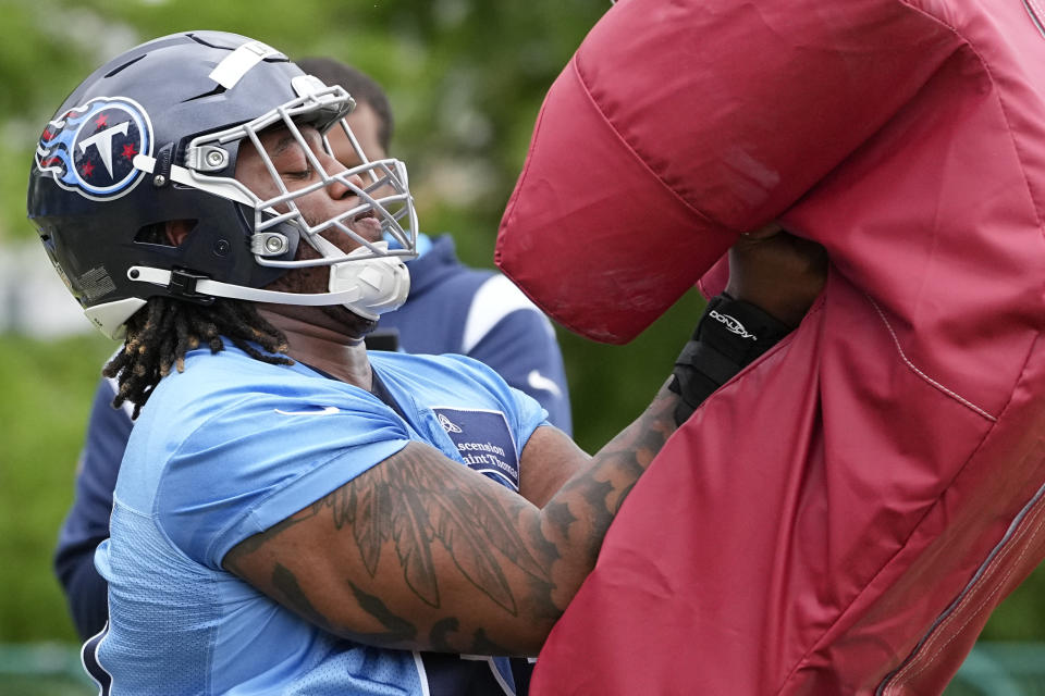 Tennessee Titans first round draft pick tackle JC Latham runs through a drill during an NFL rookie minicamp football practice Friday, May 10, 2024, in Nashville, Tenn. (AP Photo/George Walker IV)