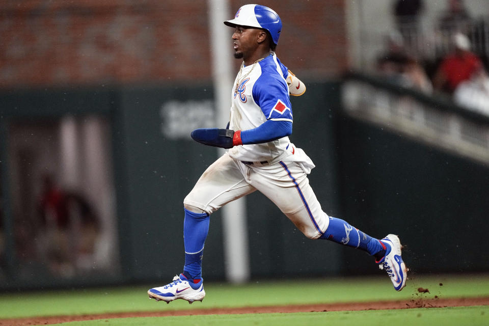 Atlanta Braves' Ozzie Albies runs on an Austin Riley line drive in the fifth inning of a baseball game against the Milwaukee Brewers, Friday, July 28, 2023, in Atlanta. Albies was safe at third base. (AP Photo/John Bazemore)