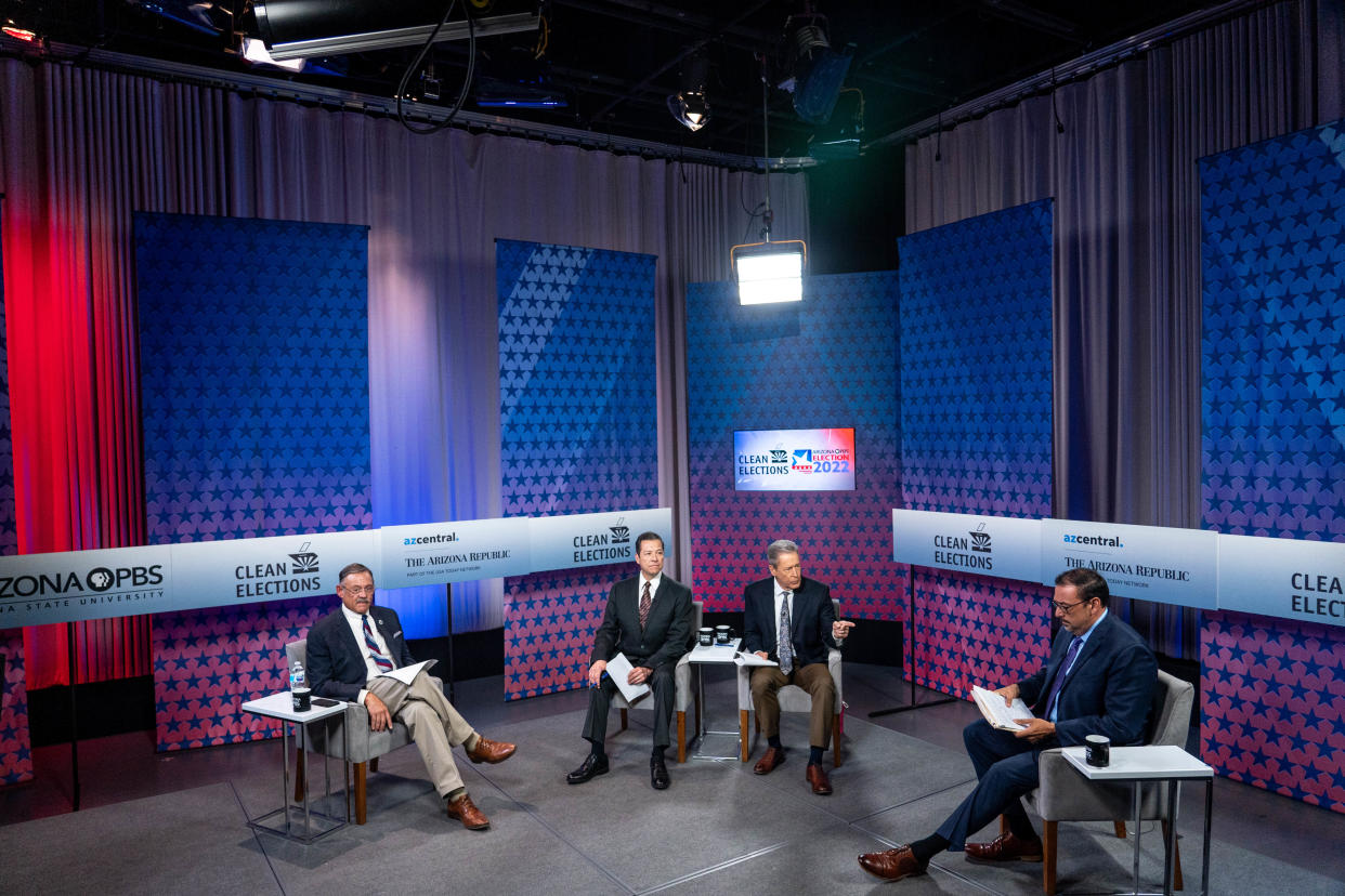 From left, Republican Mark Finchem, co-moderator Richard Ruelas, reporter at The Arizona Republic, moderator Ted Simons, host of "Arizona Horizon" on Arizona PBS, and Democrat Adrian Fontes, prepare to begin a debate for secretary of state at the Arizona PBS studios at the Walter Cronkite School of Journalism and Mass Communication at Arizona State University in Phoenix on Sept. 22, 2022.