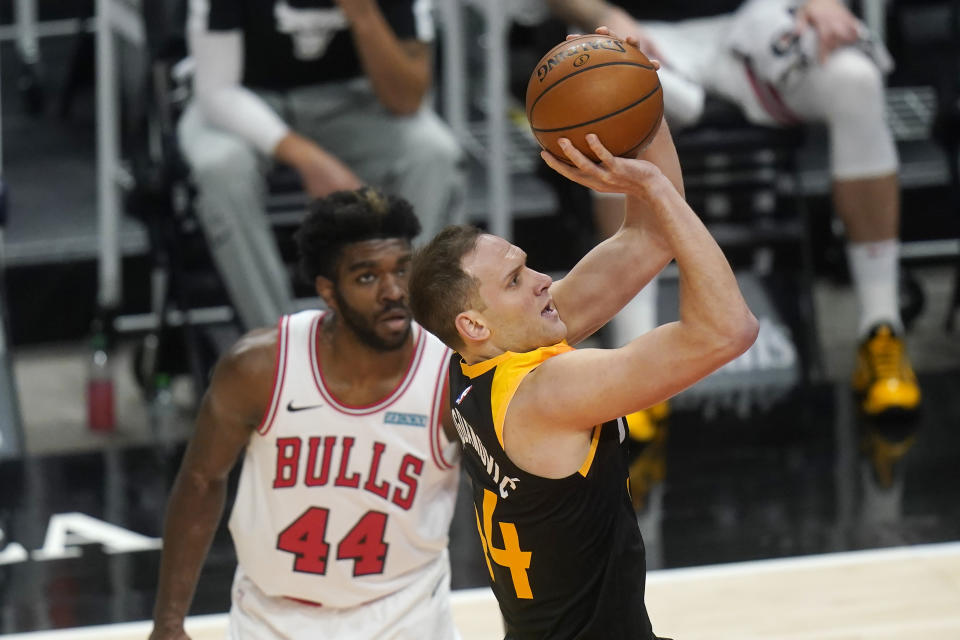 Utah Jazz forward Bojan Bogdanovic, right, shoots as Chicago Bulls forward Patrick Williams (44) looks on in the first half during an NBA basketball game Friday, April 2, 2021, in Salt Lake City. (AP Photo/Rick Bowmer)