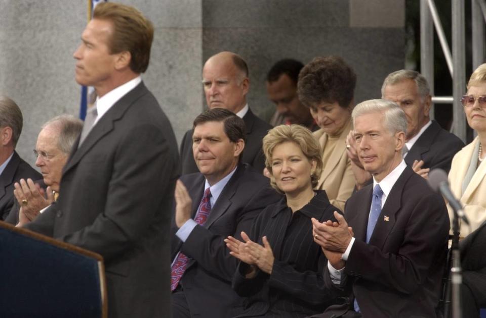 Arnold Schwarzenegger speaks after taking the oath of office for governor of California on the steps of the state Capitol on Nov. 17, 2003. Former Gov. Gray Davis and his wife Sharon look on at right.