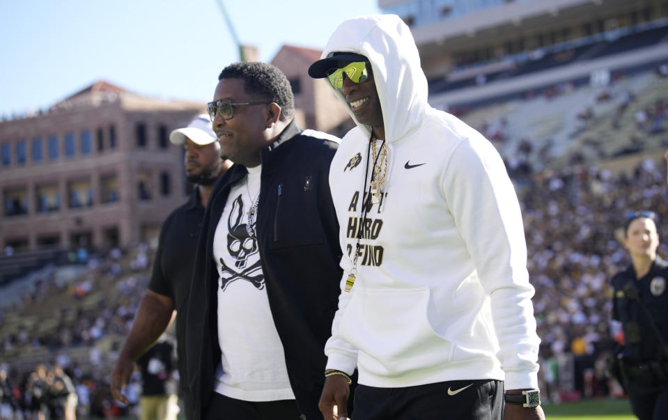 Colorado head coach Deion Sanders, front, walks the perimeter of Folsom Field before an NCAA college football game against Nebraska, Saturday, Sept. 9, 2023, in Boulder, Colo. (AP Photo/David Zalubowski)