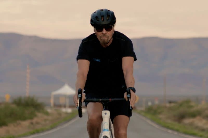 FILE PHOTO: Richard Branson arrives by bicycle to Spaceport America