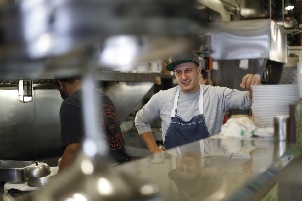 In this Wednesday, Jan. 18, 2017 photo, Ben Hall, owner of the Russell Street Deli, a sanctuary restaurant, works in the kitchen in Detroit. Dozens of restaurants are seeking “sanctuary” status, a designation owners hope will help protect employees in an immigrant-heavy industry and tone down fiery rhetoric sparked by the presidential campaign. (AP Photo/Paul Sancya)