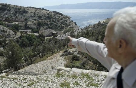 Zlatko Hill, former prisoner of Goli Otok (Barren Island), points to where he was detained at on the Goli Otok September 5, 2014. REUTERS/Antonio Bronic