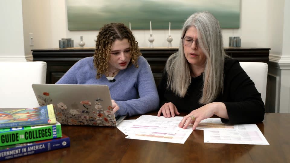 Anna and Merav look over college application materials. - CNN