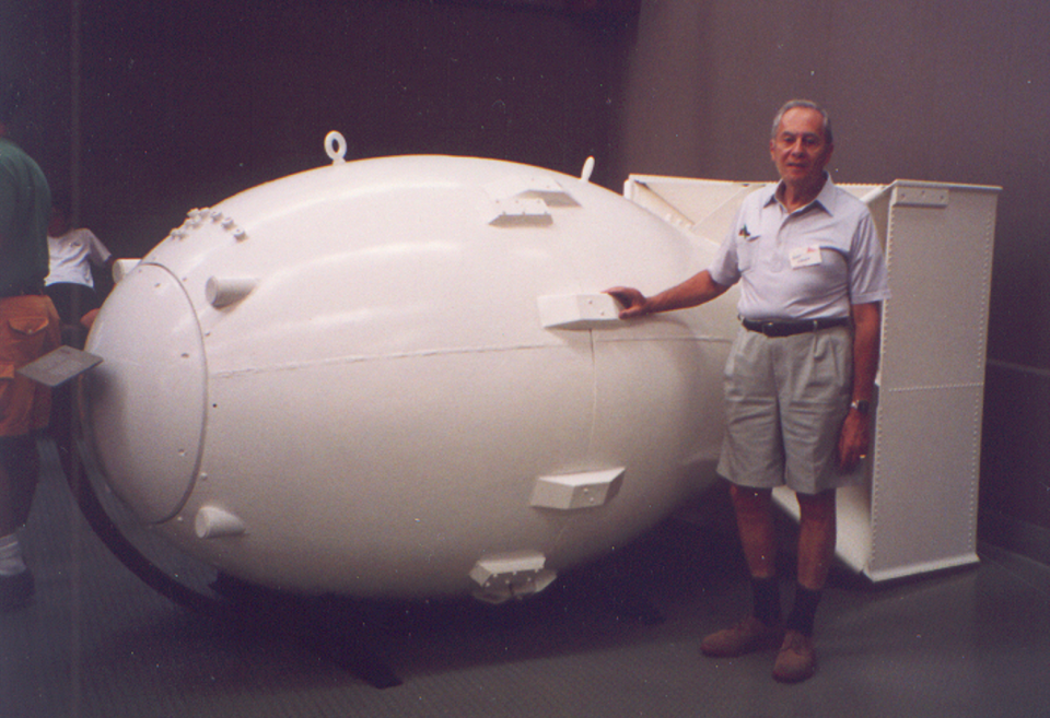 Arthur Levy poses with a replica of the "Fat Man" atomic bomb at the Bradbury Science Museum in Los Alamos, New Mexico.