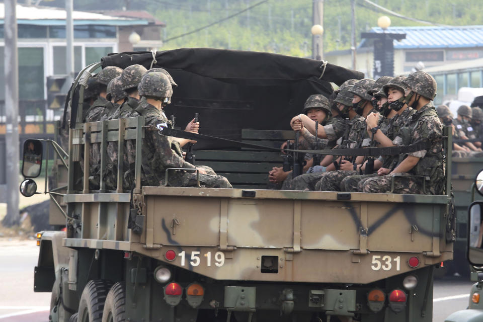 South Korean army soldiers ride on the back of a truck in Paju, near the border with North Korea, South Korea, Wednesday, June 17, 2020. North Korea said Wednesday it will redeploy troops to now-shuttered inter-Korean tourism and economic sites near the border with South Korea and take other steps to nullify landmark 2018 tension-reduction deals. (AP Photo/Ahn Young-joon)