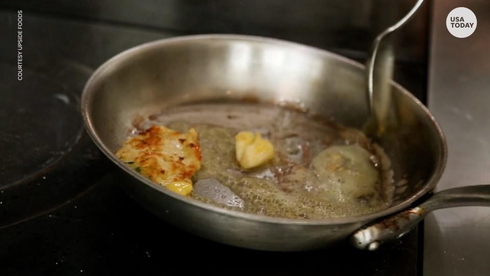 A cook prepares a sample piece of lab-grown meat. The U.S. Food and Drug Administration says it's safe to eat.