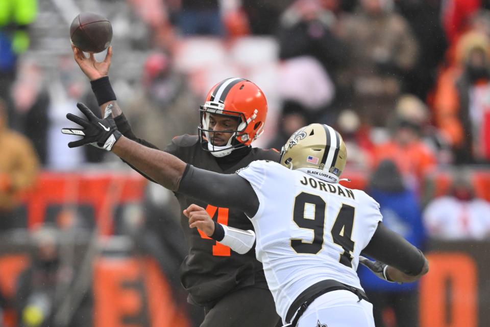 Cleveland Browns quarterback Deshaun Watson (4) is pressured by New Orleans Saints defensive end Cameron Jordan (94) during the first half of an NFL football game, Saturday, Dec. 24, 2022, in Cleveland. (AP Photo/David Richard)