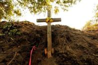 A cross is seen at the site where bulldozer operator Robert Reagan of Fresno County was killed in a rollover on July 26, 2016 while fighting the Soberanes Fire, in the Palo Colorado area north of Big Sur, California, July 31, 2016. REUTERS/Michael Fiala