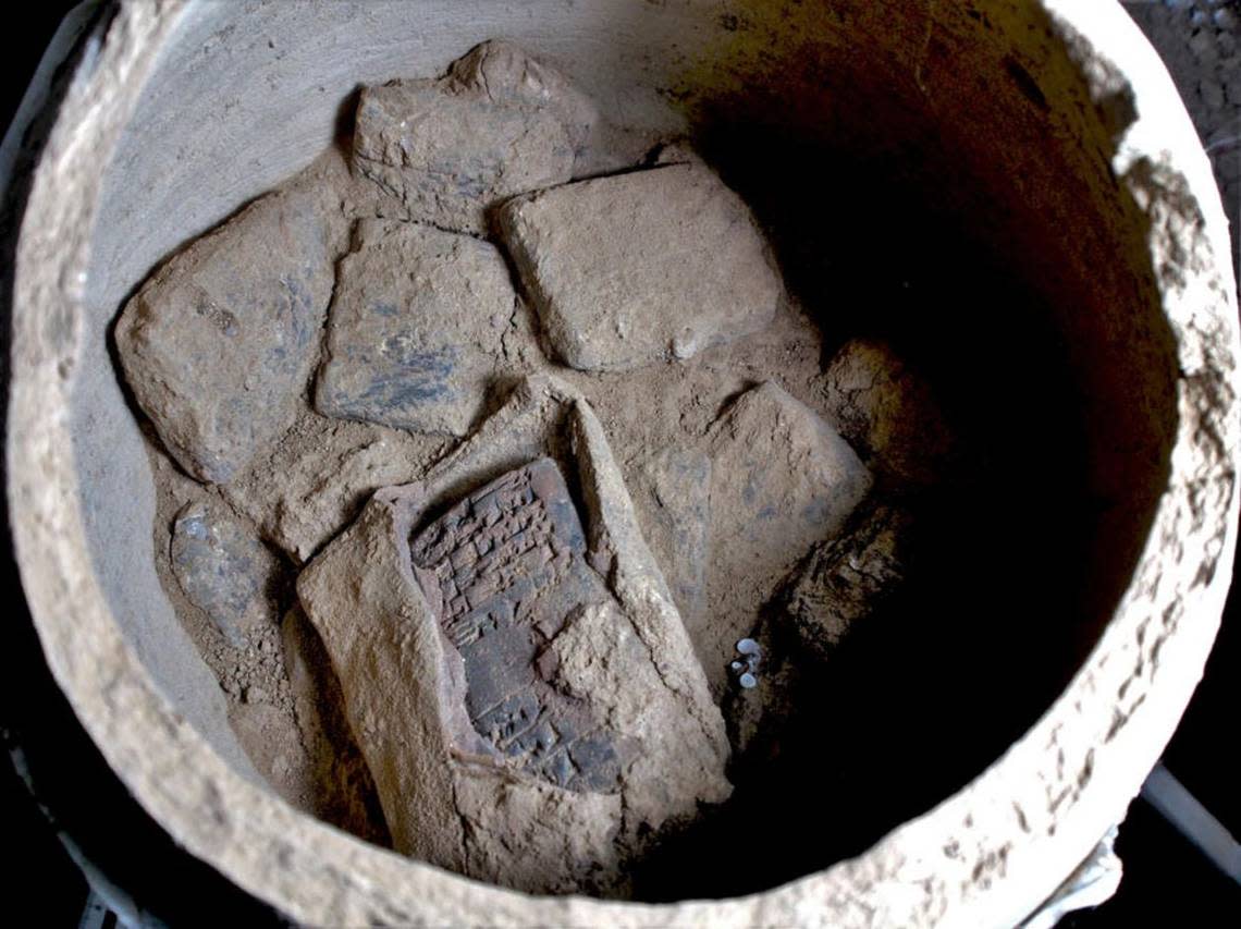 Cuneiform writing tablets were found in pottery vessels with one tablet still partially encased in its original clay envelope.