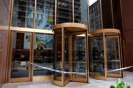 Police tape covers entrance at 787 7th Avenue one day after a helicopter crashed on the building's roof in New York