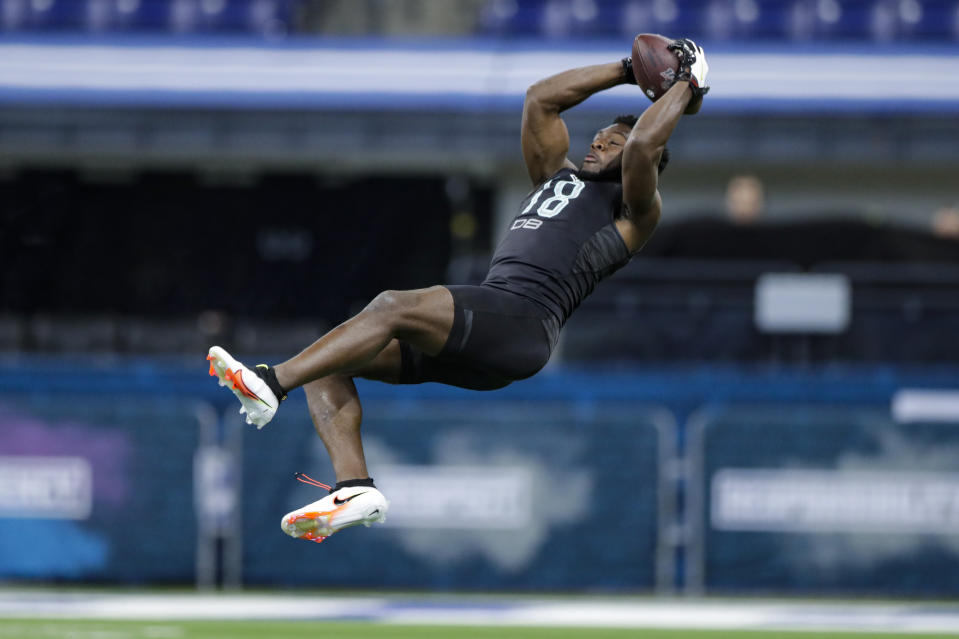 Auburn defensive back Noah Igbinoghene runs a drill at the NFL football scouting combine in Indianapolis, Sunday, March 1, 2020. (AP Photo/Michael Conroy)