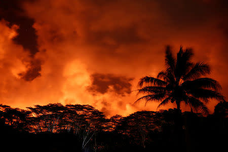 Clouds glow above a lava flow on the outskirts of Pahoa during ongoing eruptions of the Kilauea Volcano in Hawaii, U.S., May 18, 2018. REUTERS/Terray Sylvester