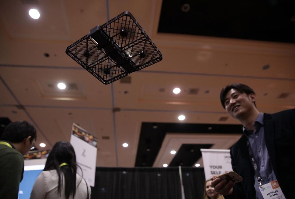 <p>Mengqiu Wang of Zero Zero Robotics demonstrates the Hover Camera Passport, a drone camera, during a press event for CES 2017 at the Mandalay Bay Convention Center on January 3, 2017 in Las Vegas, Nevada. The drone will follow you around and take photos, allowing you to join in the fun and not be stuck behind the camera. (Getty) </p>