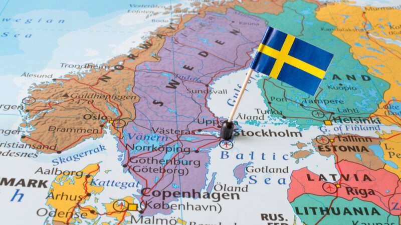 A map of Scandinavia with the Swedish flag pinned to it