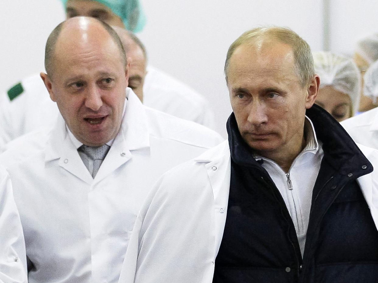 FILE - Businessman Yevgeny Prigozhin, left, shows Russian President Vladimir Putin, around his factory which produces school means, outside St. Petersburg, Russia on Sept. 20, 2010. Prigozhin, the millionaire owner of the Wagner Group private military company, has used his longtime ties with Russian President Vladimir Putin to increase his clout. (Sputnik, Kremlin Pool Photo via AP, File)