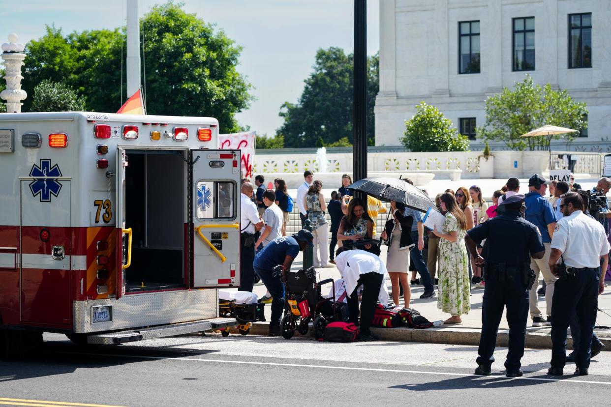 <span>Emergency workers help an elderly man who fainted during a heatwave in Washington DC on 20 June 2024.</span><span>Photograph: Andrew Leyden/NurPhoto via Getty Images</span>