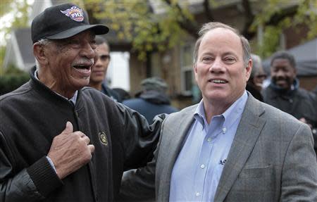 Detroit mayoral candidate Mike Duggan (R) chats with Detroit resident David Miller as he makes a campaign stop in the neighborhood he lived in as a child in Detroit, Michigan November 2, 2013. REUTERS/Rebecca Cook