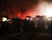 People pay respects to Portuguese soccer great Eusebio during his funeral at Lumiar cemetery in Lisbon January 6, 2014.