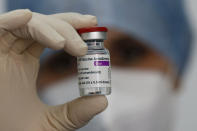 A health worker holds up a dose of the AstraZeneca vaccine against COVID-19 to be administered to members of the Italian Army at a vaccination center set up at the military barracks of Cecchignola, in Rome, Tuesday, Feb. 23, 2020. (Cecilia Fabiano/LaPresse via AP)