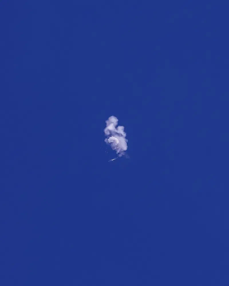 In this photo provided by Chad Fish, a large balloon is struck down above the Atlantic Ocean, just off the coast of South Carolina, Saturday, Feb. 4, 2023. (Chad Fish via AP)