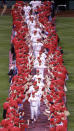 Led by pitcher Jamie Moyer, the Philadelphia Phillies are greeted as they pass through two rows of fans in center field during opening night ceremonies before the start an MLB baseball game against the Atlanta Braves, Sunday, April 5, 2009, in Philadelphia. (AP Photo/Tom Mihalek)