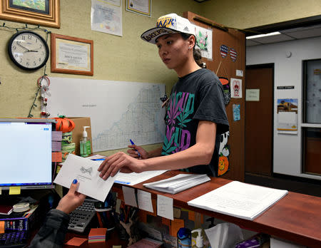 Terrell Elk, 18, votes for the first time by delivering his absentee ballot for the 2018 mid-term election to the Sioux County Auditor's office on the Standing Rock Reservation in Fort Yates, North Dakota, U.S. October 26, 2018. REUTERS/Dan Koeck