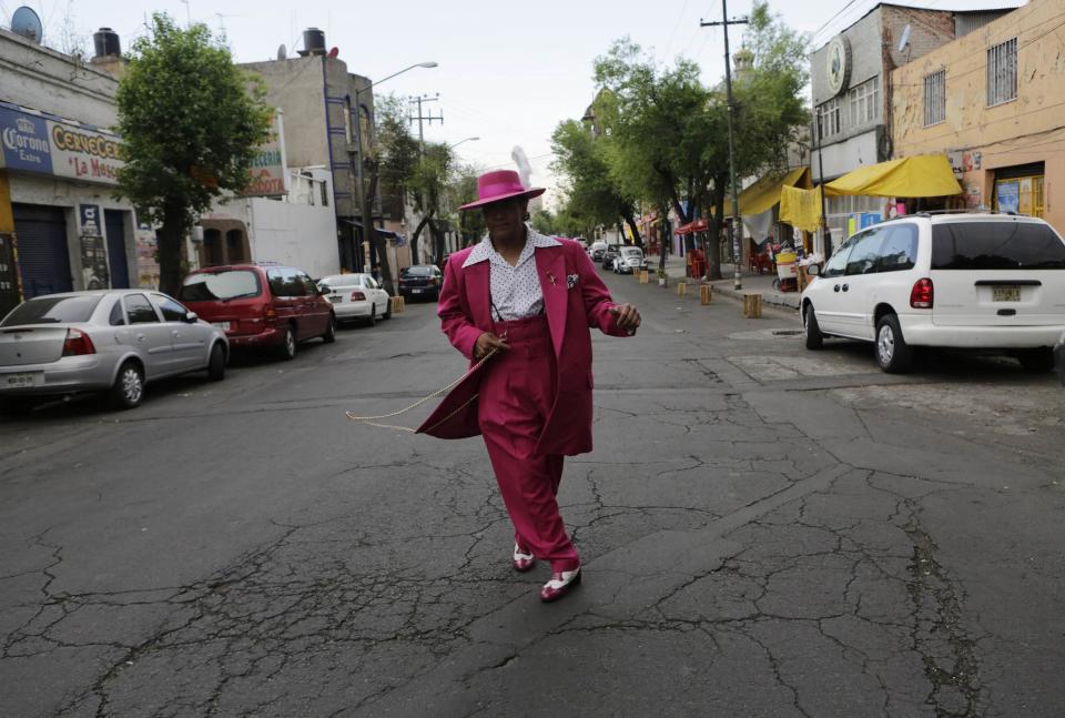 Man dressed in "Pachuco" style walks on a street in Mexico City